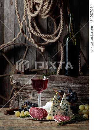 Rustic still life with wine and snacks. Rustic still life with wine and snacks. 84087054