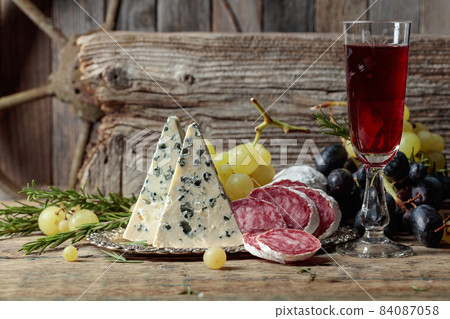 Rustic still life with wine and snacks. 84087058