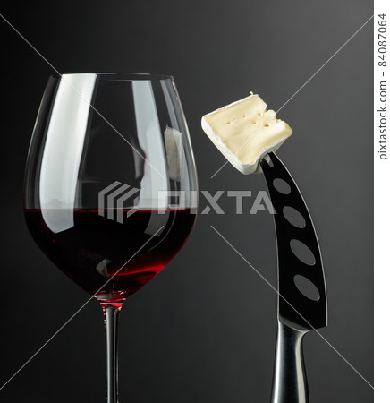 Red wine and soft cheese on a knife. Red wine and soft cheese on a knife. 84087064