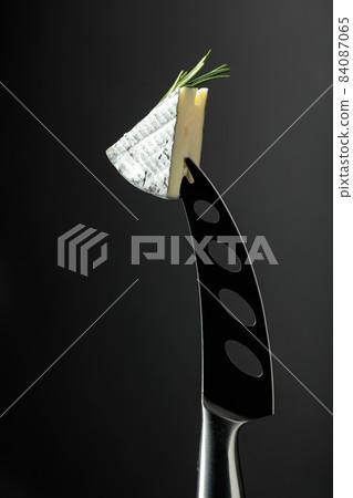 Soft cheese on a knife. Soft cheese on a knife. 84087065