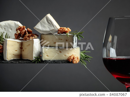 Red wine and soft cheeses with walnuts and rosemary. Red wine and soft cheeses with walnuts and rosemary. 84087067