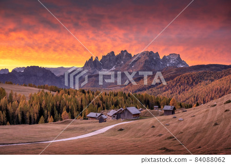 Incredible red sunset at Fuchiade valley in Italian Dolomites countryside Incredible red sunset at Fuchiade valley in Italian Dolomites countryside 84088062