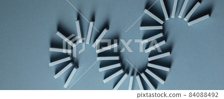 Light Blue wood domino pieces on light blue background. Leisure games concept. Light Blue wood domino pieces on light blue background. Leisure games concept. 84088492