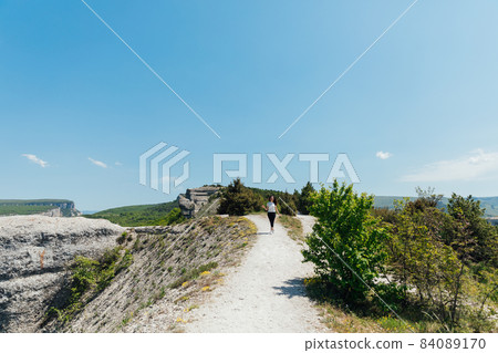 woman traveler walking on top of the mountain 84089170