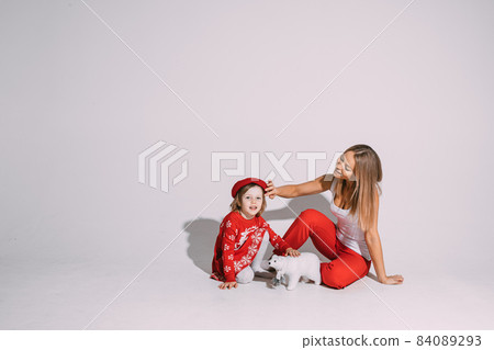 Beautiful young woman patting cute child on her Beautiful young woman patting cute child on her 84089293