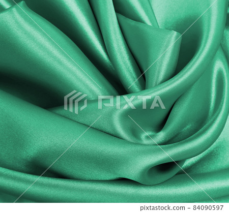 Smooth elegant green silk or satin luxury cloth texture as abstract background. Luxurious background design Smooth elegant green silk or satin luxury cloth texture as abstract background. Luxurious background design 84090597