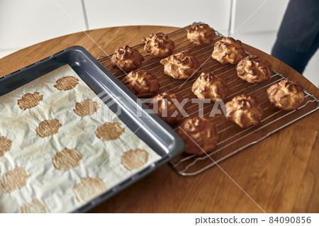 Professional confident woman is preparing custard cakes at light modern kitchen at home 84090856