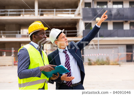 Architect and engineer talking about project of new building 84091046