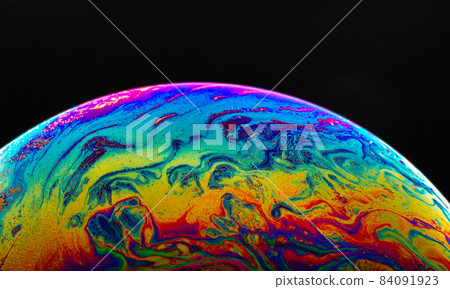 Virtual reality space with abstract multicolor psychedelic planet. Closeup Soap bubble like an alien planet on black background. Virtual reality space with abstract multicolor psychedelic planet. Closeup Soap bubble like an alien planet on black background. 84091923