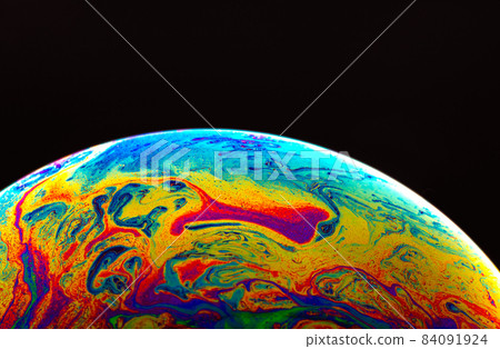Virtual reality space with abstract multicolor psychedelic planet. Closeup Soap bubble like an alien planet on black background. Virtual reality space with abstract multicolor psychedelic planet. Closeup Soap bubble like an alien planet on black background. 84091924