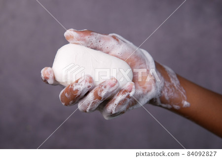 young man washing hands with soap warm water young man washing hands with soap warm water 84092827