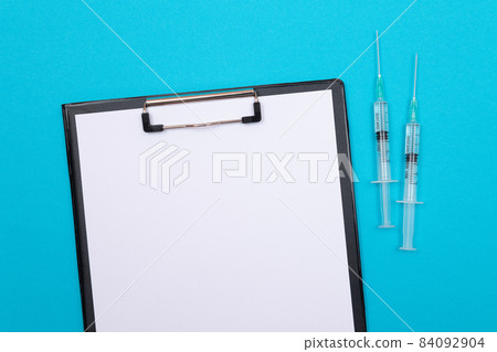 Vaccination or Revaccination Concept - Two Medical Syringe on Blue Table 84092904