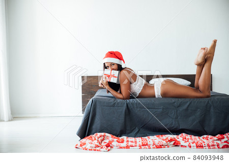 beautiful woman in lingerie for Christmas gift New Year in the bedroom beautiful woman in lingerie for Christmas gift New Year in the bedroom 84093948