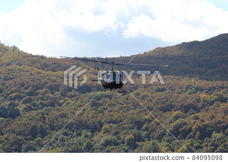 The helicopter in flight over the wood The helicopter in flight over the wood 84095098
