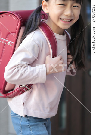 Elementary school girl going to and from school 84097255