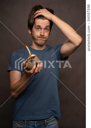 Man with mate cup on grey 84097896