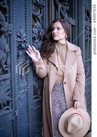 Romantic pretty woman near the old door Romantic pretty woman near the old door 84097938