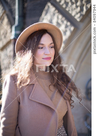 Romantic pretty woman with arch behind 84097944