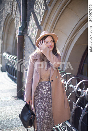 Romantic pretty woman with arch behind 84097946