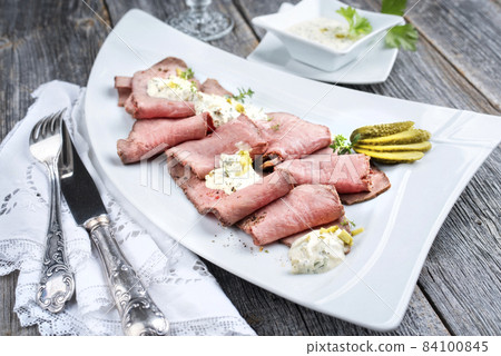 Traditional lunch meat with sliced cold cuts roast beef and remoulade offered Traditional lunch meat with sliced cold cuts roast beef and remoulade offered 84100845