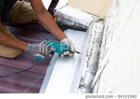 Roof repair, Worker with steel sheet. Stop a roof leak Roof repair, Worker with steel sheet. Stop a roof leak 84101840
