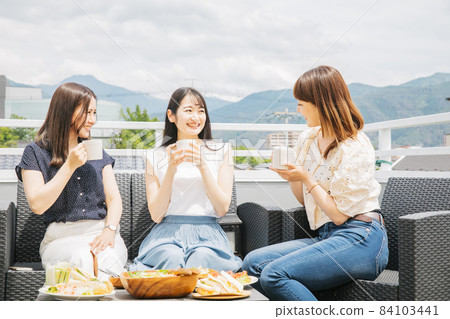Women having a tea party on the roof 84103441