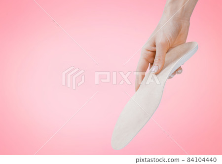 Orthopedic insole isolated on a pink background. Medical insoles. Treatment and prevention of flat feet and foot diseases. Foot care, feet comfort. Wear comfortable shoes. Flat Feet Correction. Orthopedic insole isolated on a pink background. Medical insoles. Treatment and prevention of flat feet and foot diseases. Foot care, feet comfort. Wear comfortable shoes. Flat Feet Correction. 84104440