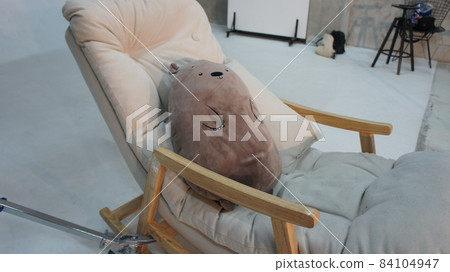 Soft toy lies on a rocking chair Soft toy lies on a rocking chair 84104947