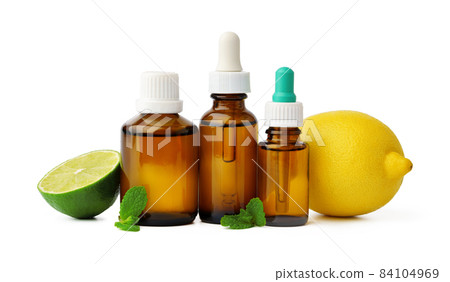 Essential oil bottles and citrus fruit on white background 84104969