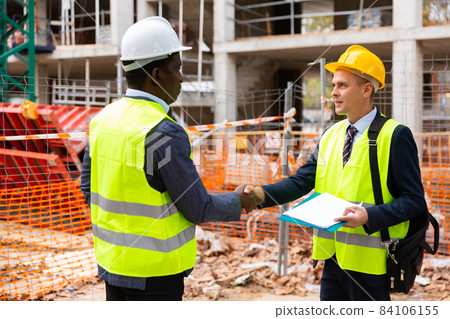 Engineers shaking hands on construction site Engineers shaking hands on construction site 84106155