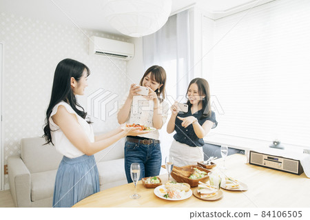 Women having a home party (taken with a smartphone) 84106505