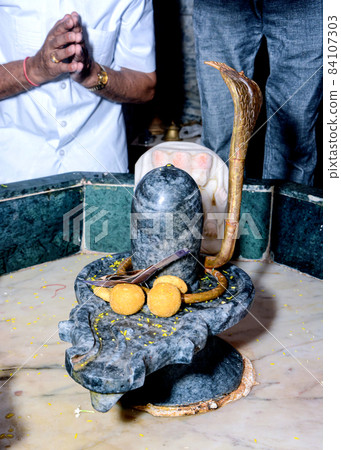 Closeup of Shiva Linga statue, a symbol or Icon of Hindu God Shiva used to perform puja or prayers Closeup of Shiva Linga statue, a symbol or Icon of Hindu God Shiva used to perform puja or prayers 84107303