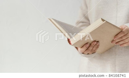close up hands holding open book. High quality beautiful photo concept 84108741