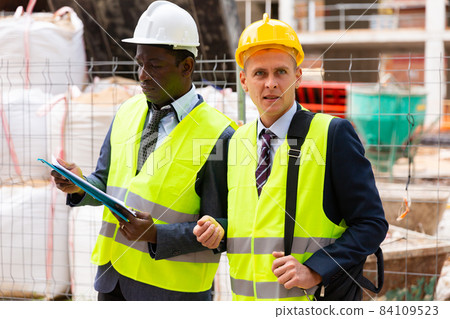 Portrait of two engineers with a folder of working documents 84109523