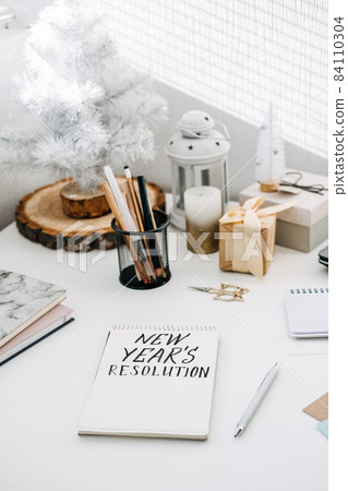 New years resolution, New goals. Handwritten Text New years resolution in open notepad on the table. Start new year, planning and setting goals for the next year 84110304