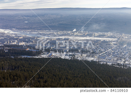 Siberian city of Ust-Kut on the Lena River among the taiga hills at the beginning of winter. 84110910