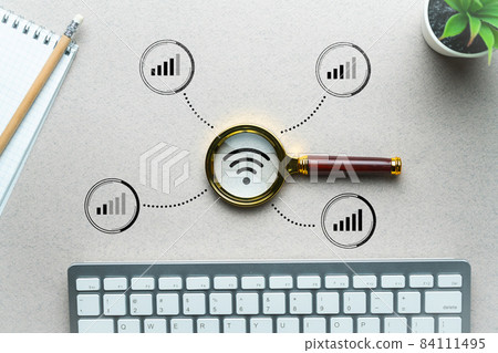 WiFi home network search concept. Magnifying glass on the table. 84111495