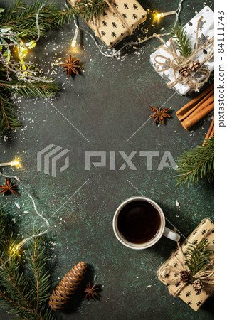 Winter concept. Flatlay composition with Christmas presents and cup of  coffee on a dark stone background. Copy space. 84111743