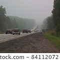 highway going into a foggy distance. car flow 84112072