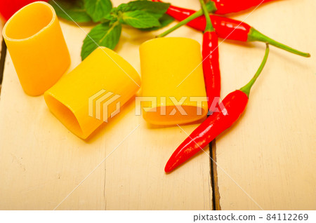 Italian pasta paccheri with tomato mint and chili pepper 84112269