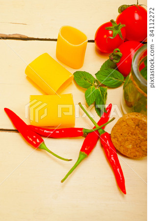 Italian pasta paccheri with tomato mint and chili pepper Italian pasta paccheri with tomato mint and chili pepper 84112272