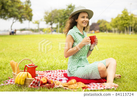 Beautiful young woman having picnic. 84113724