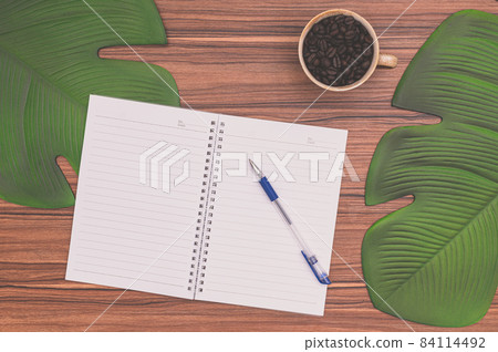 Notebook and coffee mug On the desk Notebook and coffee mug On the desk 84114492