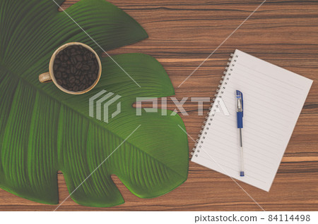 Notebook and coffee mug On the desk Notebook and coffee mug On the desk 84114498