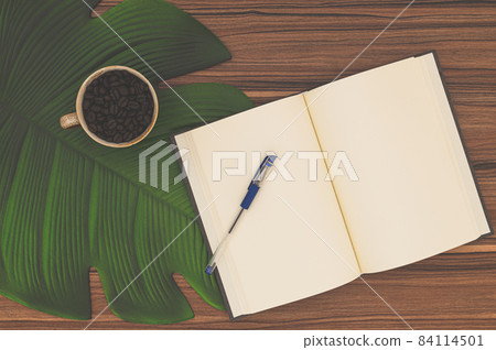 Notebook and coffee mug On the desk Notebook and coffee mug On the desk 84114501