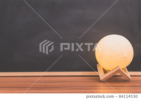Moon shape lamp On the desk Blackboard background Moon shape lamp On the desk Blackboard background 84114530