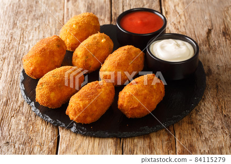 Creamy Salted Cod Croquettes Croquetas De Bacalao close up in the slate plate. Horizontal 84115279