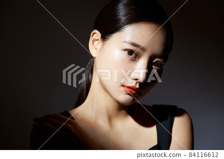 Beauty portrait on black background with contrast of light and shadow Beauty portrait on black background with contrast of light and shadow 84116612