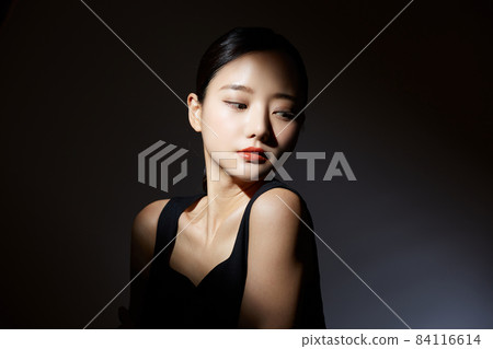 Beauty portrait on black background with contrast of light and shadow Beauty portrait on black background with contrast of light and shadow 84116614