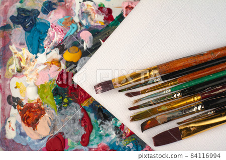 artist palette with blank white canvas and brushes Stock Photo